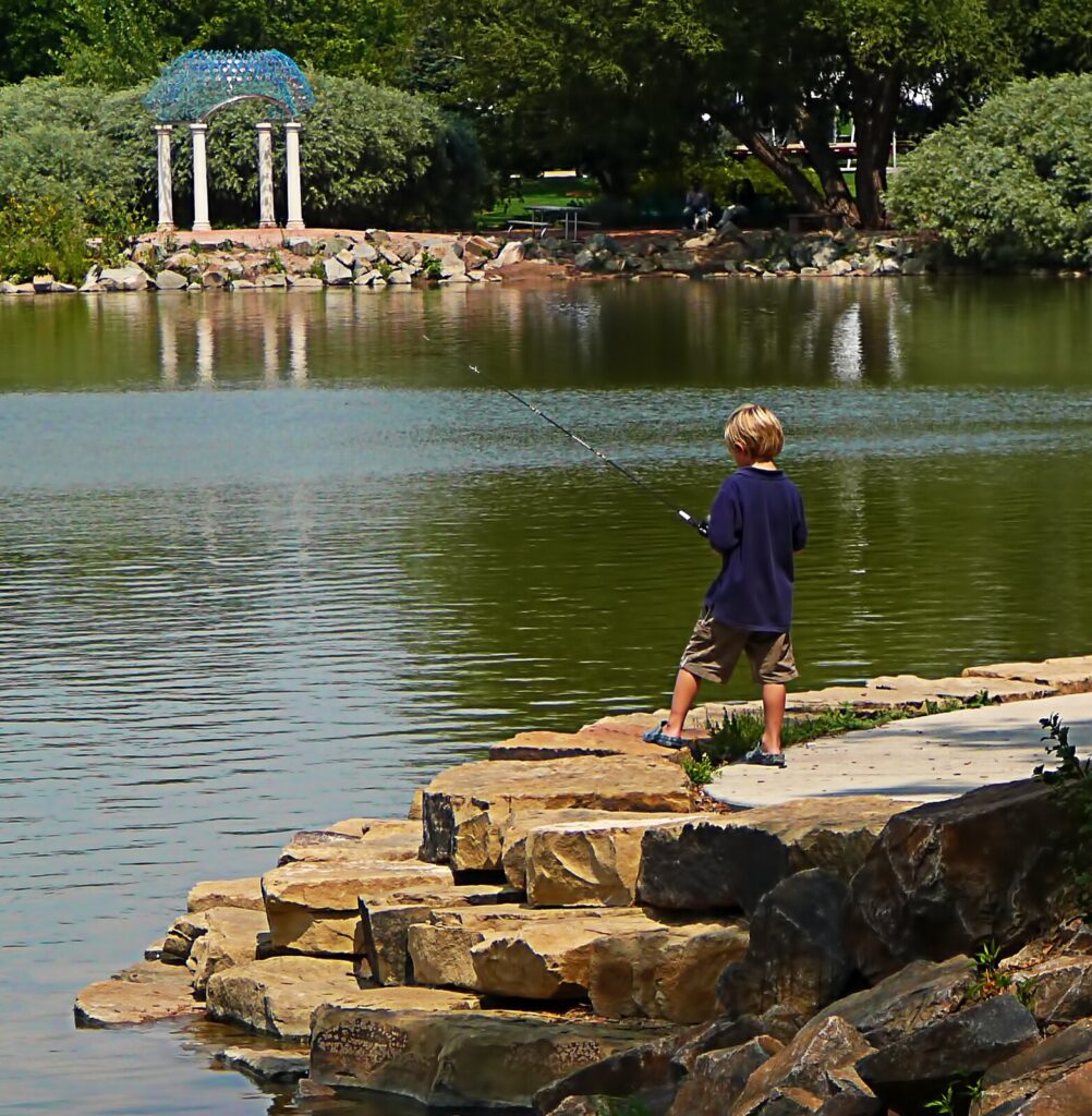 City Park in Fort Collins, Co. A boy fishing on Sheldon Lake